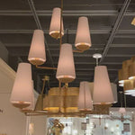 We love the textured look of the Fontaine Vertical Chandelier by Visual Comfort. The layered linen shades brings a classy, warm look to any living room, dining room, or other large area.   Designer: AERIN