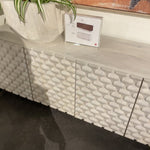 We love the texture of this Rio Media Console - Round Cut White Wash. Made from solid mango with spacious interior shelving and a rear cutout for card management, this is a beautiful piece to add to any living room or entertainment area.   Overall Dimensions: 82.00"w x 18.25"d x 28.00"h