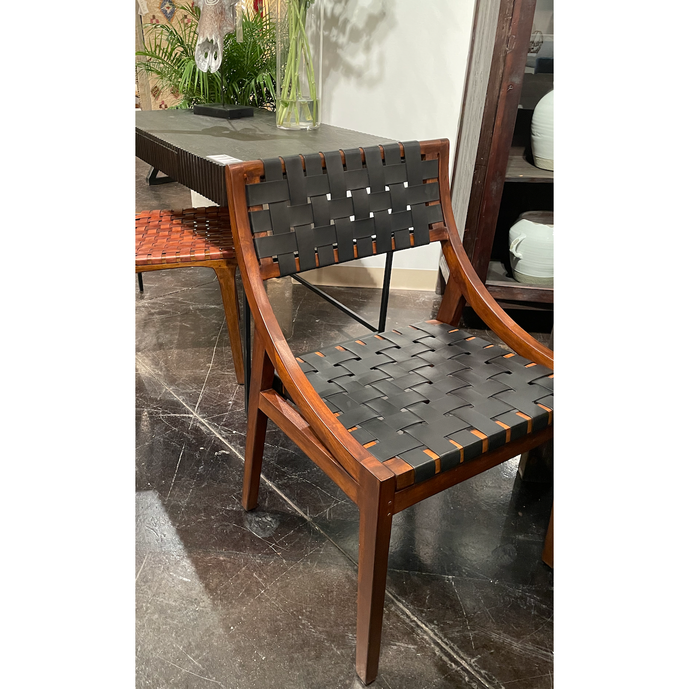 Featuring Camila Dining Chair by Dovetail at Amethyst Home. The details are simply amazing on this Camila Dining Chair. Add extra seating with a side chair that's as much a masterpiece of design as it is comfortable. 
Teak Frame with Full Grain Leather Weaving
Frame in Medium Brown and Black Leather
Size: 21"l x 17"d x 33"h.  Amethyst Home provides interior design, new home construction design consulting, vintage area rugs, and lighting in the Winter Garden metro area.