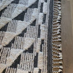 A nod to timeless Moroccan style, the Khalid Collection is hand-knotted in India by skilled artisans. The soft pile features 100% natural, undyed wool, lending slight variations in tones that make each piece it's own. Plus, each rug is finished with a thoughtfully designed fringe.  Hand Knotted 100% Wool KF-02 Natural/Black