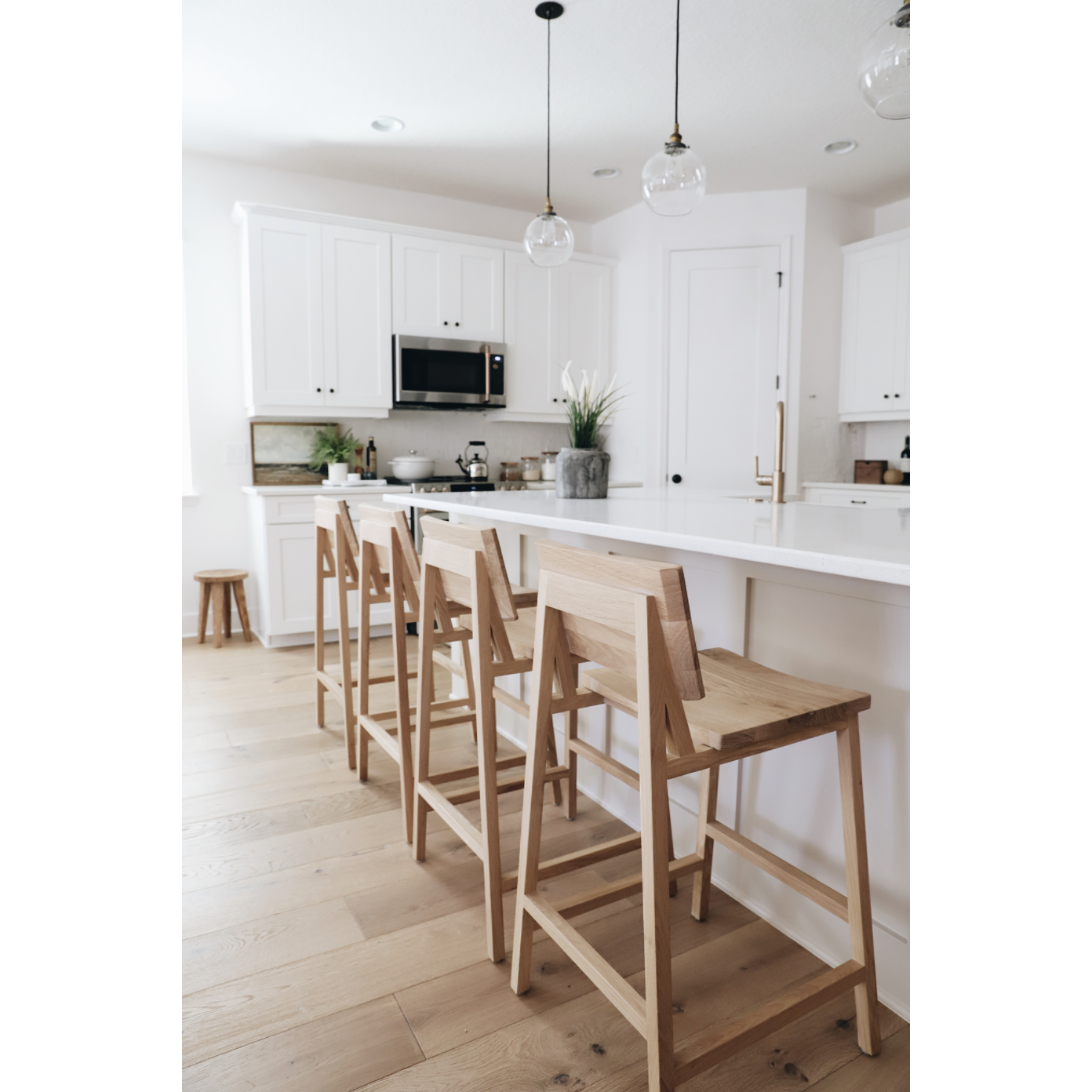 Featuring Oak N3 Counter Stool by Ethnicraft at Amethyst Home. We love the versatility of this Oak N3 counter stool. Designed by Nathan Yong, this stool is a timeless piece that adds both modern lines and a cozy organic aesthetic to your bar area or kitchen island.
Dimensions: 19.5"w x 20"d x 36"hSeat Height: 26"
Material: Oak, 100% Solid WoodFinish: Oiled 
F.  Amethyst Home provides interior design, new home construction design consulting, vintage area rugs, and lighting in the Boston metro area.