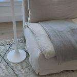 A casual, slipcovered chunky linen sectional by Cisco Brothers, the Laguna 2pc Sectional is the ultimate in casual luxury.  A down-filled seat cushion is supported by springs in a gentle, resting position.  Pair with a one-of-a-kind statement rug for a signature look. Shown in Otis White 100% linen.  Overall dimensions: 113"w x 31"h x 113"d Seat Space: 96"w x 96"d x 16"h