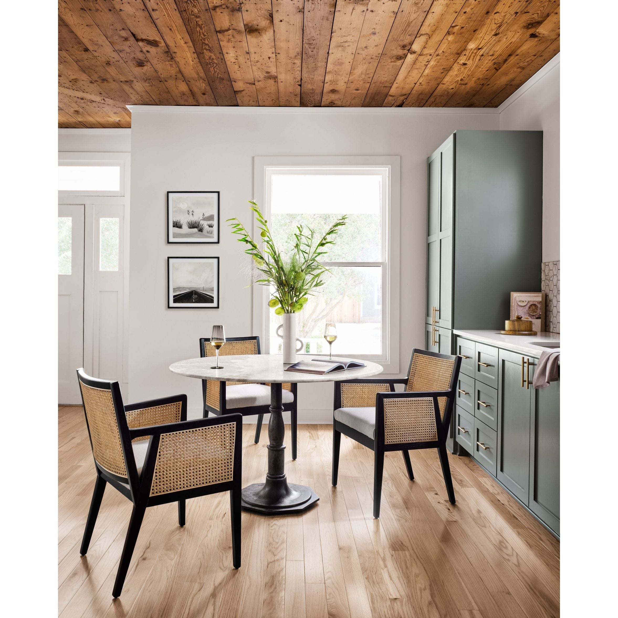 Featuring Antonia Cane Brushed Ebony Dining Armchair by Four Hands at Amethyst Home. We loved the retro look of this Antonia Cane Dining Armchair - Brushed Ebony. The brushed ebony nettlewood frames paired with the natural cane brings the perfect contract to any dining room or kitchen area. 
Overall Dimensions: 22.75"W x 23.50"L x 33"HColors: Light Natur.  Amethyst Home provides interior design, new home construction design consulting, vintage area rugs, and lighting in the Los Angeles metro area.