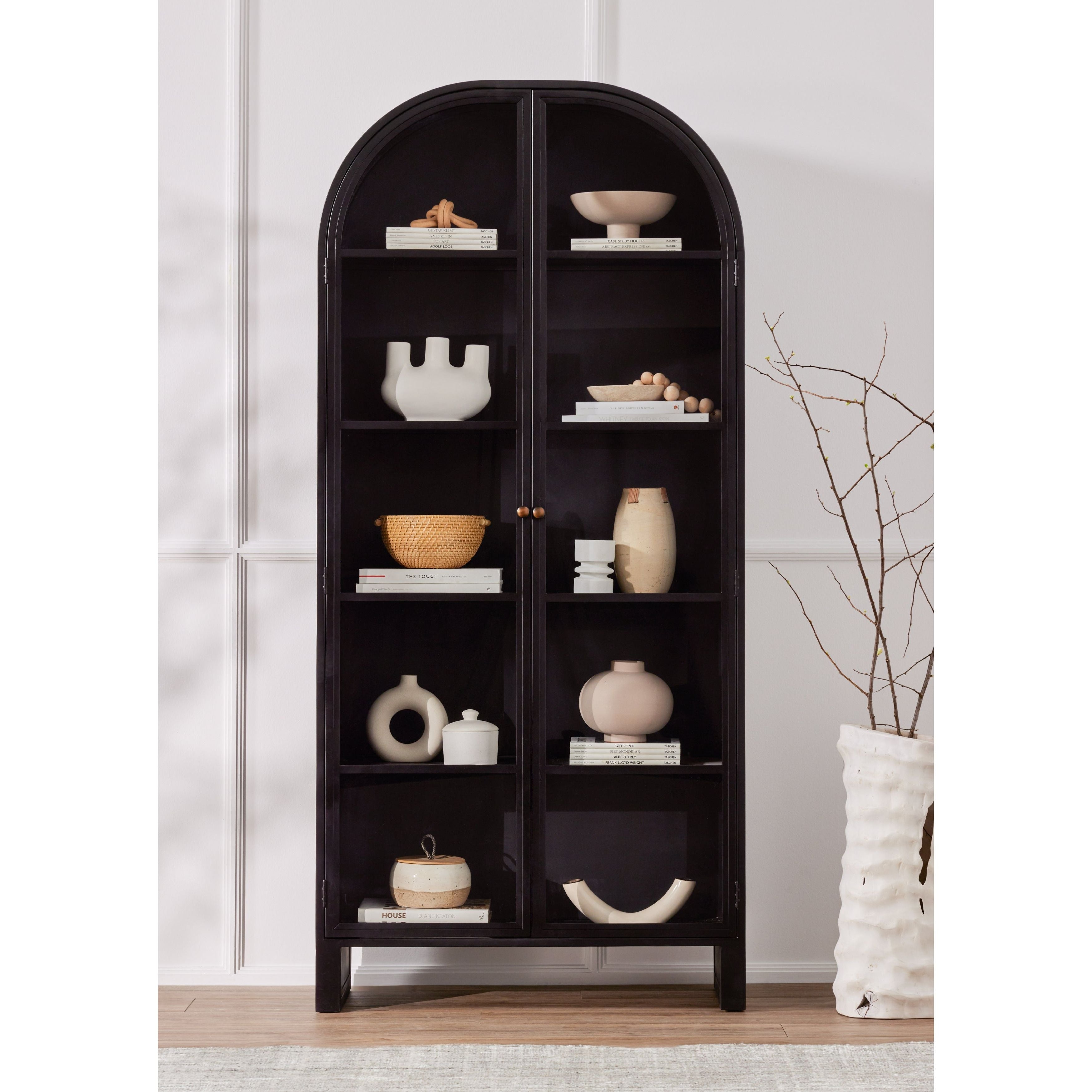 Store it in style with this Breya Cabinet - Black. Made from black-finished iron, beautifully arched cabinetry features glass-front doors, ideal for storing and displaying favorite books, photos, keepsakes, and more.  Overall Dimensions: 40.00"w x 16.25"d x 86.75"h