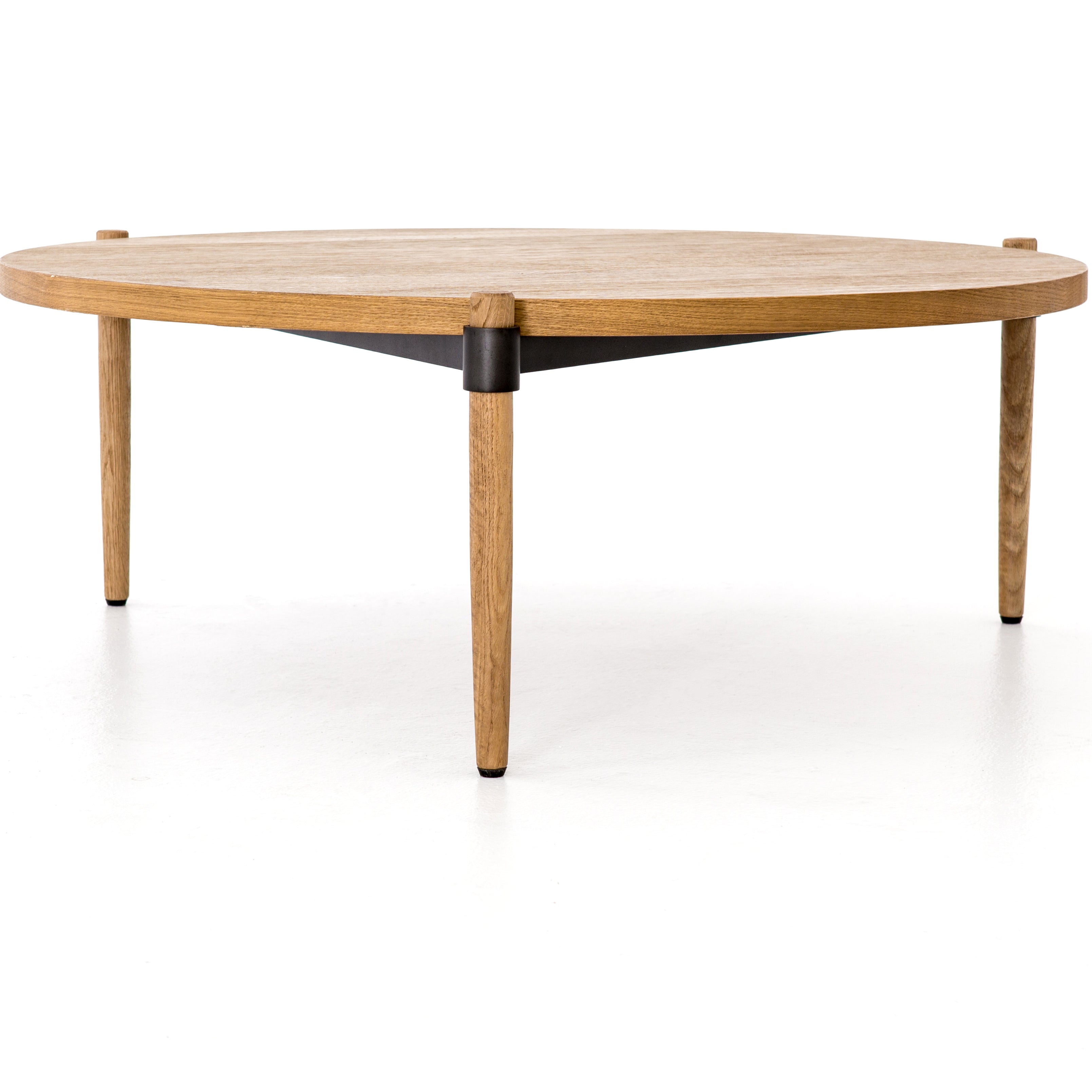 Featuring Holmes Coffee Table by Four Hands at Amethyst Home. Stunning simplicity with a Danish-inspired spin. A rounded tabletop of smoked drift oak offsets a triad of slim, tapered legs. Waxed black joinery adds a fresh look of high contrast. Pair with matching cocktail table for a nested, layered look.
Overall Dimensions: 43"W x 43"L x 14.75"H
Colors: S.  Amethyst Home provides interior design, new home construction design consulting, vintage area rugs, and lighting in the Park City metro area.