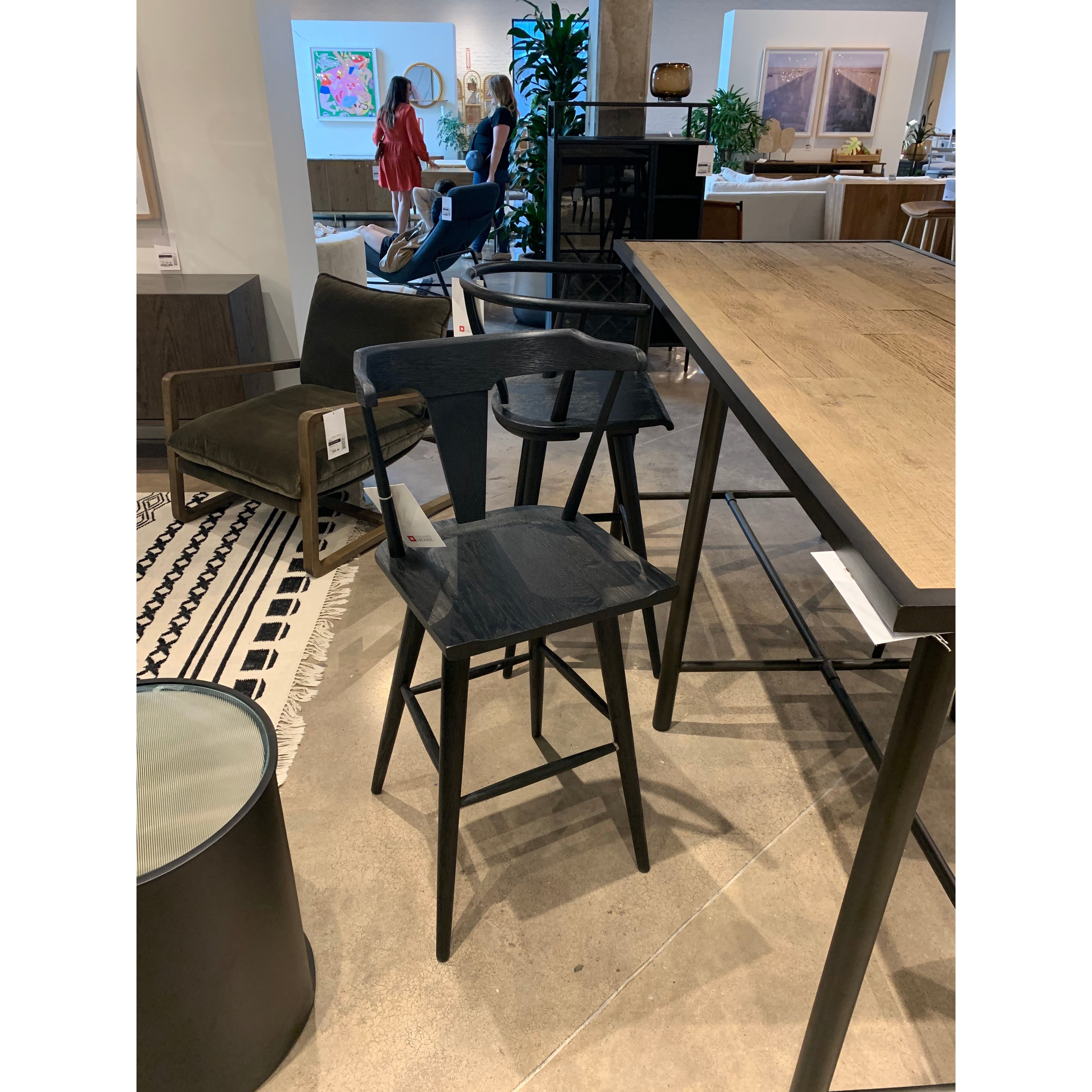 Featuring Ripley Black Oak Bar + Counter Stool by Four Hands at Amethyst Home. A fresh, bar-style take on mid-century Windsor seating is found in this Ripley Black Oak Bar + Counter Stool. Featuring a bowed, sculptural silhouette and soft black finish to highlight the natural grain of weathered oak.
Bar Overall Dimensions: 20.50"W x 20"L x 42.25"HSeat Depth: .  Amethyst Home provides interior design, new home construction design consulting, vintage area rugs, and lighting in the Boston metro area.
