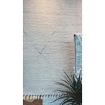 Featuring Alpine Manesa Hand-Knotted  Rug by Jaipur Living at Amethyst Home. Inspired by textiles from the Tullu region in Morocco, the Alpine Manesa rug brings texture and versatility to both global and modern spaces. Crafted of natural wool, the hand-knotted Alpine Manesa rug features a plush, ridged feel and an erased, asymmetrical trellis design in cream.  Amethyst Home provides interior design, new home construction design consulting, vintage area rugs, and lighting in the Houston metro area.