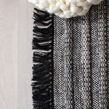 Featuring Castillo Torre Rug - Jet Black by Jaipur Living at Amethyst Home. The handwoven Castillo Torre Area Rug - Jet Black features a soft feel and relaxed, versatile style. The Torre area rug showcases a rich blend of black, gray, and rust tan tones for a grounding, neutral look. Crafted of PET yarn, or recycled plastic, this durable and textured rug b.  Amethyst Home provides interior design, new home construction design consulting, vintage area rugs, and lighting in the Nashville metro area.