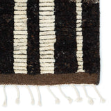 Featuring Keoka Quest Mole Hand-Knotted Rug by Jaipur Living at Amethyst Home. The Keoka Quest Mole Area Rug boasts a fresh take on classic Afghani hand-knotted textiles. In rich, grounding tones of deep brown and ivory, the stylish contrast of the Quest rug anchors room with bold yet neutral appeal. The texture-rich wool pile features a ribbed constru.  Amethyst Home provides interior design, new home construction design consulting, vintage area rugs, and lighting in the Newport Beach metro area.