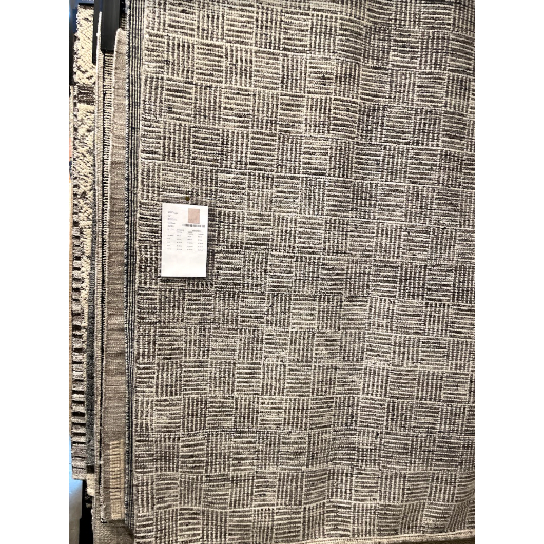 Featuring Rize Mugler Hand-Knotted Rug by Jaipur Living at Amethyst Home. The Rize Mugler Area Rug offers intricate and delicately designed global patterns to the modern home. A thatched square motif creates an eye-catching geometric design on the artistically distressed Mugler area rug. In an earthy ivory and black colorway, this durable hand-knotted wo.  Amethyst Home provides interior design, new home construction design consulting, vintage area rugs, and lighting in the Kansas City metro area.