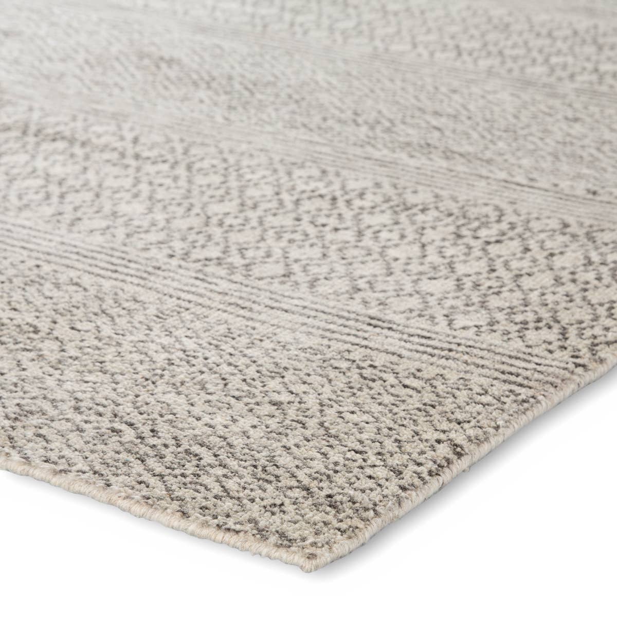 Featuring Rize Neema Hand-Knotted Rug by Jaipur Living at Amethyst Home. The Rize Neema Area Rugs offers intricate and delicately designed global patterns to the modern home. Small-scale geometric motifs create a captivating banded design on the artistically distressed Neema area rug. In a light neutral colorway of white and gray, this durable hand-kno.  Amethyst Home provides interior design, new home construction design consulting, vintage area rugs, and lighting in the Newport Beach metro area.