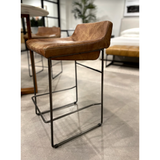 Upgrade your kitchen or dining room with this sleek, cocktail-ready Starlet Counter + Bar Stool - Open Road Brown Leather that showcases poise and comfort. This adds a cool sophistication to your space with its slim iron frame and luxe leather upholstery.