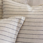 The Blake Duvet Collection Flax/Midnight by Pom Pom at Home features an interwoven stripe texture, giving a modern refresh to a traditional stripe. Our duvet and shams are hand-loomed by artisans and the linen is washed for a relaxed lived-in look for any bedroom.   Inserts sold separately 100% linen Shell-button closure Machine wash cold; tumble dry low; warm iron as needed. Do not bleach