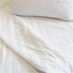 The Brussels Coverlet Bedding White by Pom Pom at Home is a grand and sophisticated line that has a diamond quilted pattern on the front, made of 100% stone washed cotton velvet. Available in several soft, stone washed colors.  100% cotton velvet Machine wash cold; tumble dry low; warm iron as needed Do not bleach