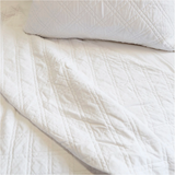 The Brussels Coverlet Bedding White by Pom Pom at Home is a grand and sophisticated line that has a diamond quilted pattern on the front, made of 100% stone washed cotton velvet. Available in several soft, stone washed colors. 100% cotton velvet Machine wash cold; tumble dry low; warm iron as needed Do not bleach