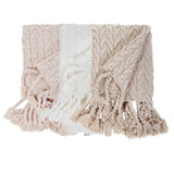 This Capistrano Throw - Three Colors is a soft cable knit throw featuring Pom Pom at Home's popular long twisted tassels along the edge. Available in 3 gentle colors. Size: 50" x 70" Material: 100% Acrylic