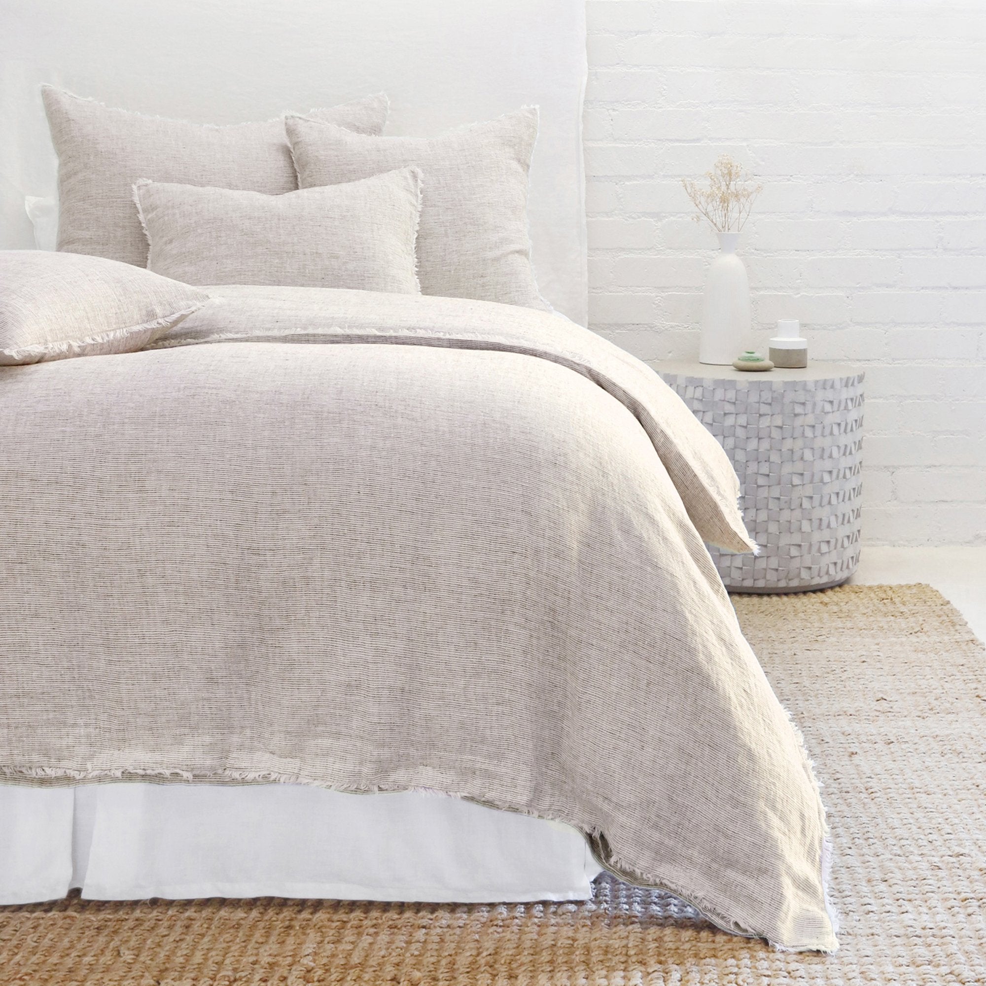 Subtle frayed edges of soft linen add a dash of unexpected detail to this Logan Duvet Collection Terra Cotta by Pom Pom at Home. Woven with two different colored yarns for a heathered effect, the duvet cover and shams feature shell button closures. Inserts sold separately 100% linen Shell-button closure Machine wash cold; tumble dry low; warm iron as needed. Do not bleach