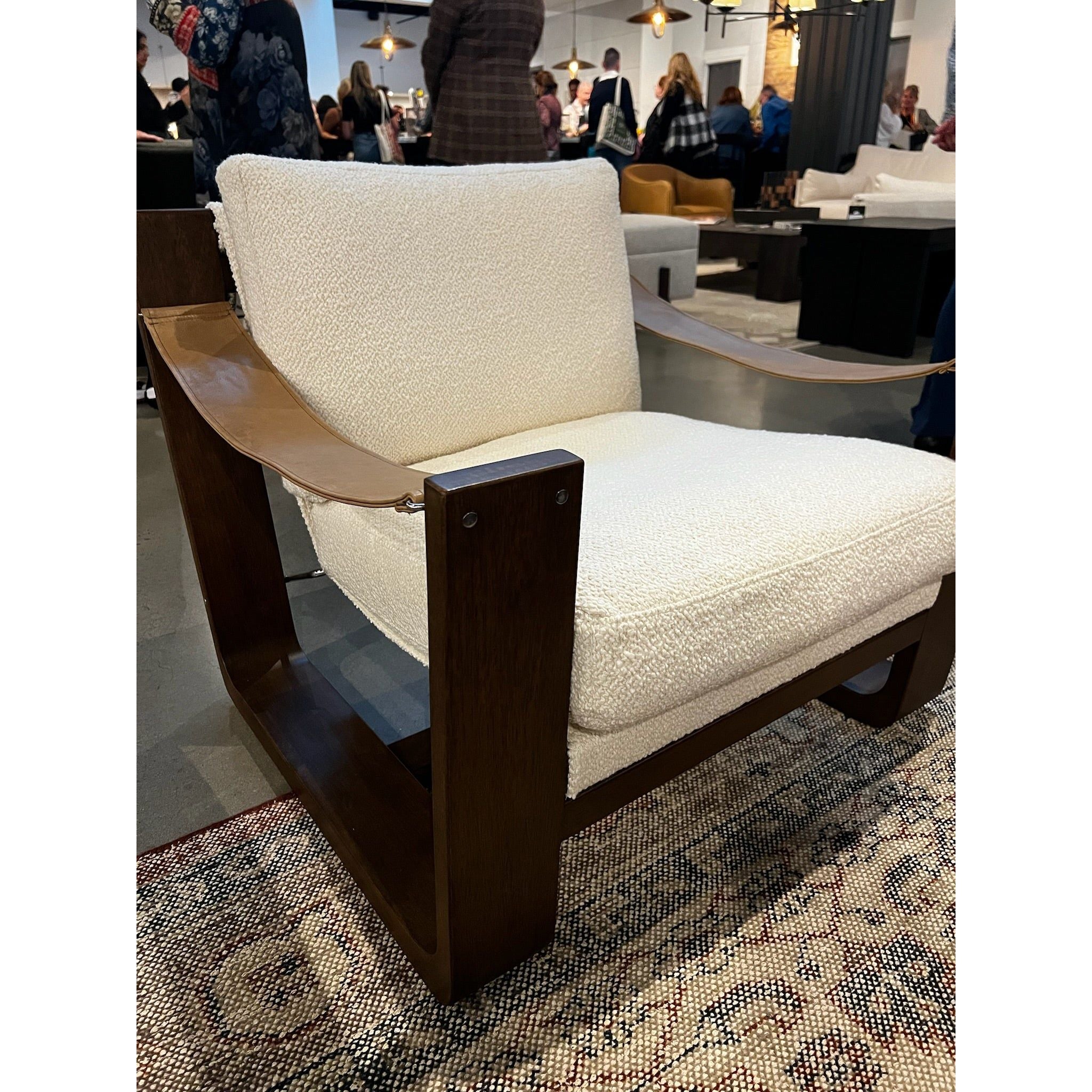 The classic sling chair gets a grand, elevated look. Solid wood frame is shaped, curved and smoothed on all edges. Cushioned seat and back are upholstered in top-grain leather. Amethyst Home provides interior design, new home construction design consulting, vintage area rugs, and lighting in the Charlotte metro area.