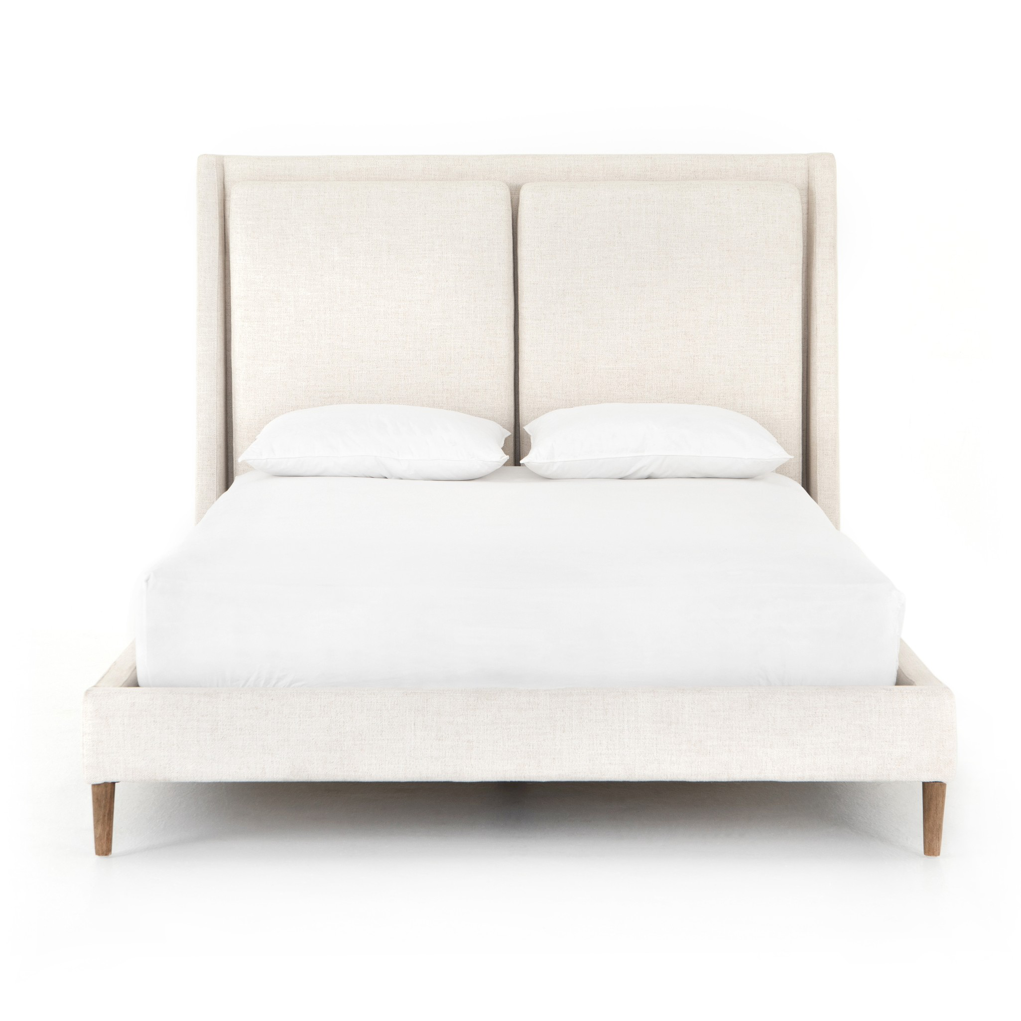 Welcome light, livable luxury into your bedroom with a fully upholstered bed. A tapered headboard features a fixed oversized cushion of high-performance fabric, creating a soft, layered look. Understated wooden legs complete the design. Amethyst Home provides interior design, new home construction design consulting, vintage area rugs, and lighting in the Los Angeles metro area.