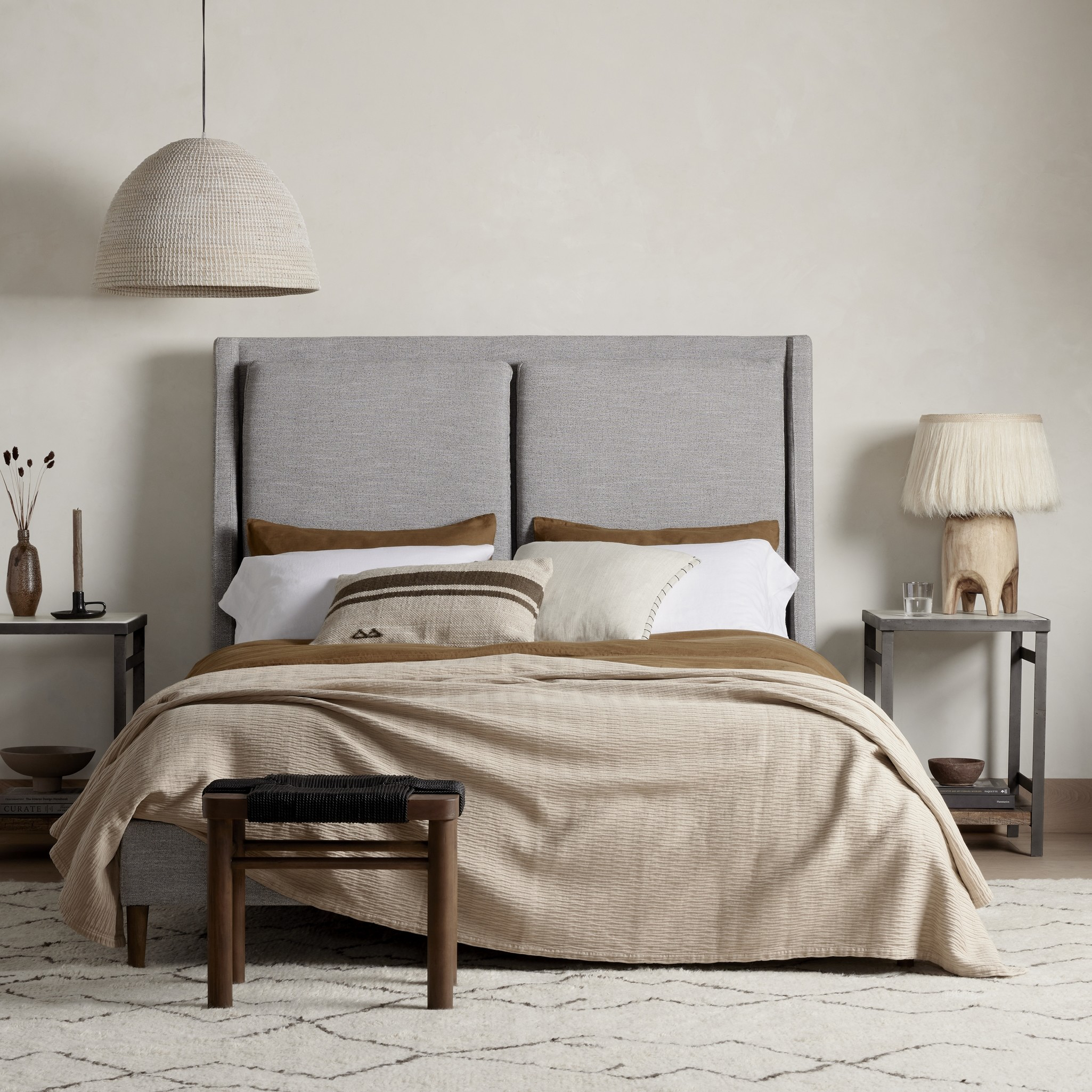 Featuring Potter Manor Grey Bed by Four Hands at Amethyst Home. Light, livable luxury. Upholstered in a grey synthetic-blend, a tapered headboard features fixed overscale pillows, for a calming look with great depth. Wire-brushed parawood legs lend a warm, natural finishing touch. Performance fabrics are specially created to withstand spills, stains, high tr. Amethyst Home provides interior design, new home construction design consulting, vintage area rugs, and lighting in the Monterey metro area.