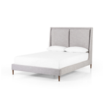 Featuring Potter Manor Grey Bed by Four Hands at Amethyst Home. Light, livable luxury. Upholstered in a grey synthetic-blend, a tapered headboard features fixed overscale pillows, for a calming look with great depth. Wire-brushed parawood legs lend a warm, natural finishing touch. Performance fabrics are specially created to withstand spills, stains, high traf. Amethyst Home provides interior design, new home construction design consulting, vintage area rugs, and lighting in the Dallas metro area.
