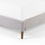Featuring Potter Manor Grey Bed by Four Hands at Amethyst Home. Light, livable luxury. Upholstered in a grey synthetic-blend, a tapered headboard features fixed overscale pillows, for a calming look with great depth. Wire-brushed parawood legs lend a warm, natural finishing touch. Performance fabrics are specially created to withstand spills, stains, high traff. Amethyst Home provides interior design, new home construction design consulting, vintage area rugs, and lighting in the Tampa metro area.