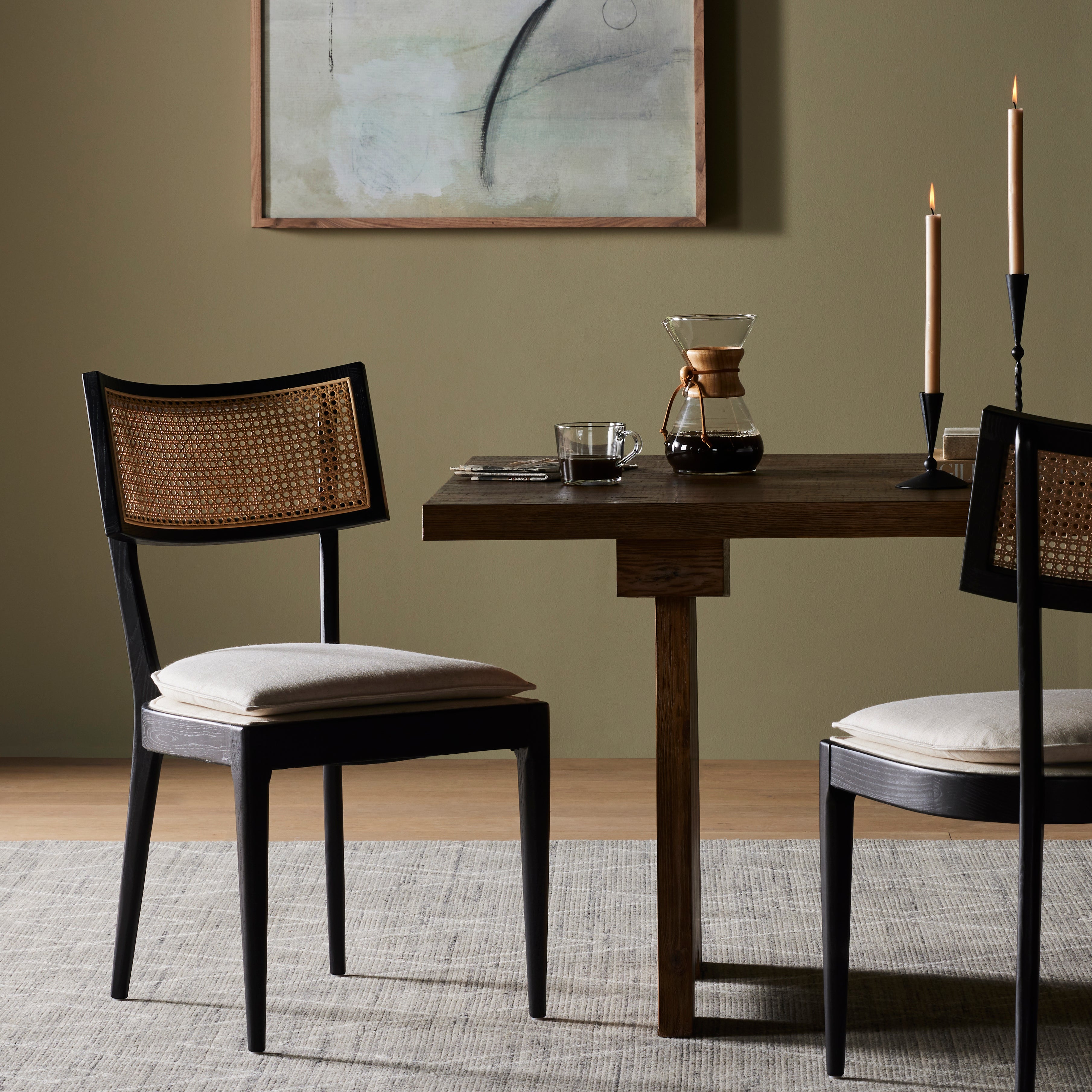 Mixed materials refresh retro dining style. Ebony-finished nettlewood frames a textural inlay of natural cane, for perfect contrast. Fastened by Velcro, high-performance linen-blend seating for modern sensibility. Performance fabrics are specially created to withstand spills, stains, high traffic and wear, ensuring long-term comfort and unmatched durability. Amethyst Home provides interior design, new construction, custom furniture and area rugs in the Oklahoma City metro area
