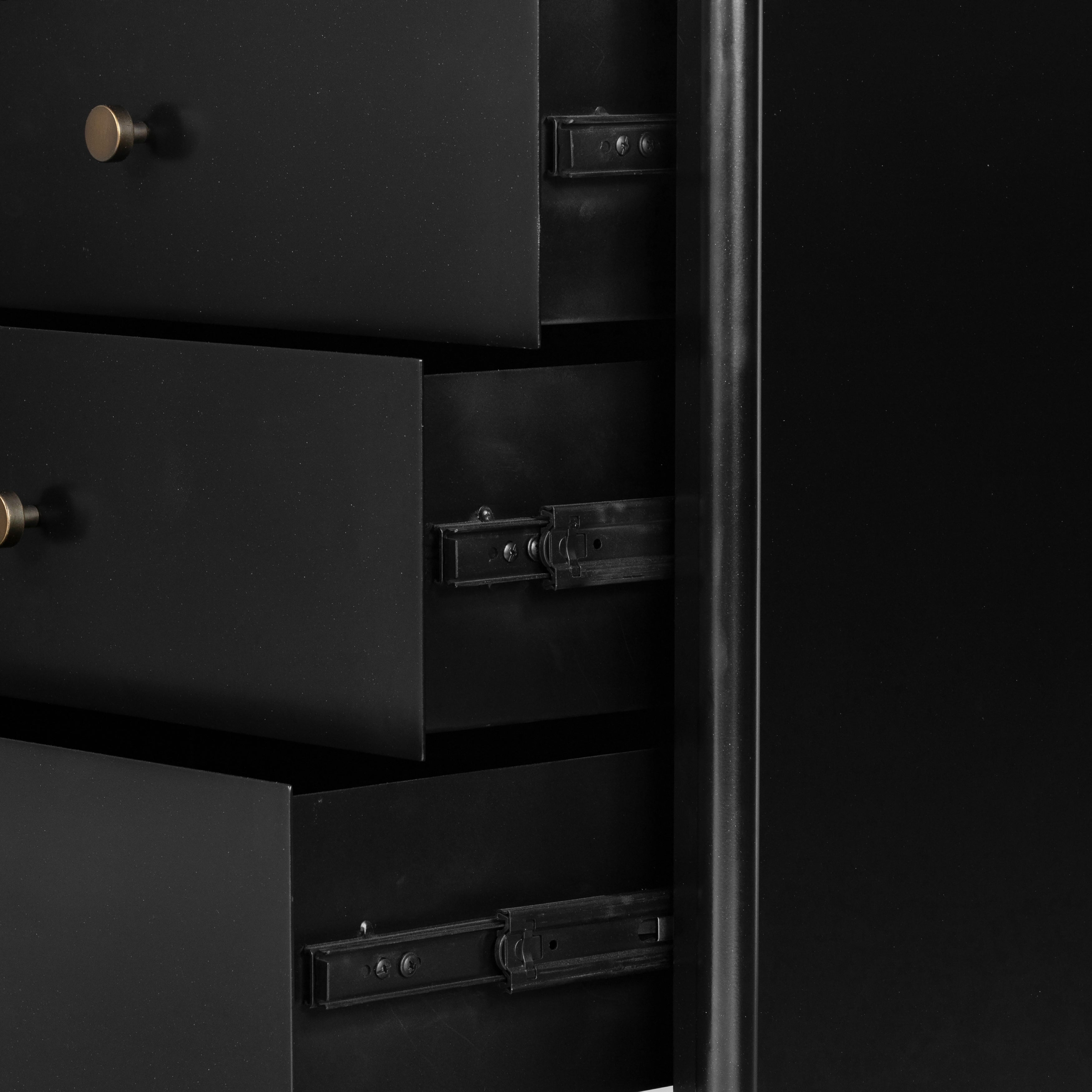 Bring a clean, beautifully industrial look to the bedroom with a three-drawer dresser made from black-finished iron, featuring bronzed iron hardware.