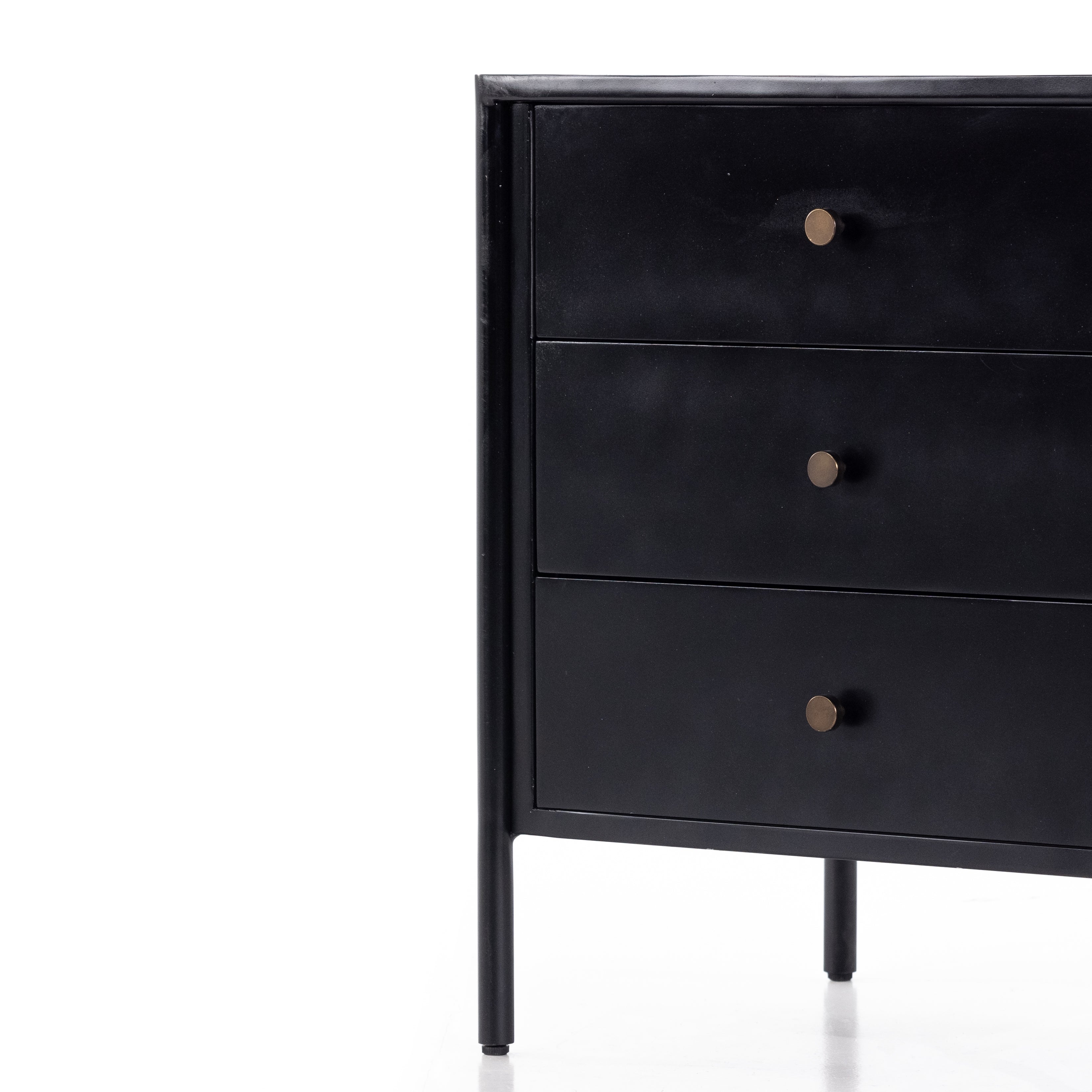 Bring a clean, beautifully industrial look to the bedroom with a three-drawer dresser made from black-finished iron, featuring bronzed iron hardware.