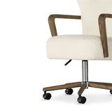 A comfort-driven desk chair features soft, textural upholstery, framed by solid ash arms. A height-adjustable swivel base with casters makes for ease in the modern office. Amethyst Home provides interior design, new home construction design consulting, vintage area rugs, and lighting in the Malibu metro area.