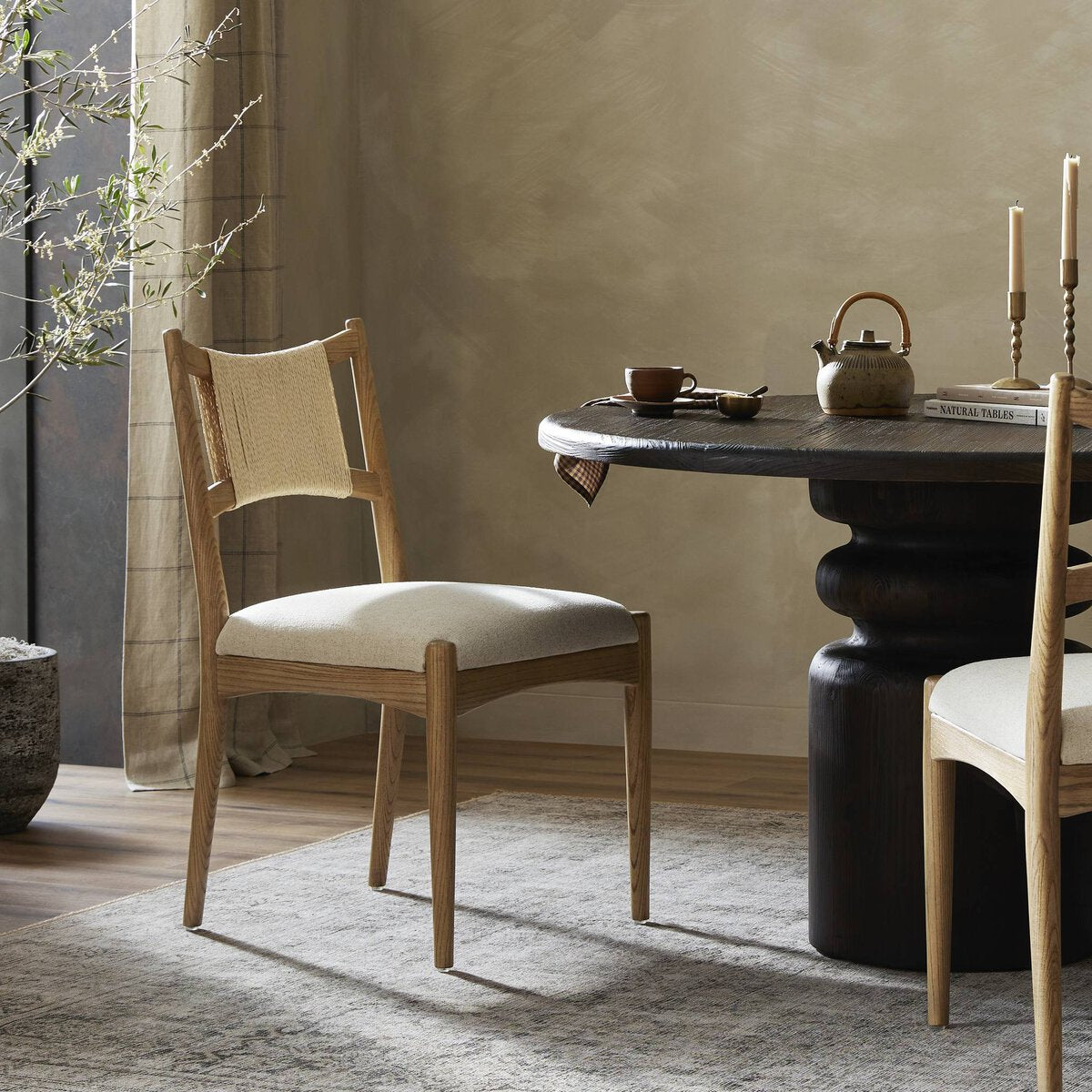 Expertly crafted by Haddon Antwerp, the Natural Dining Chair is both stylish and sturdy. With its sleek design and high-quality materials, this chair is perfect for adding a touch of elegance to your dining room. Its ergonomic shape provides optimal comfort, making it ideal for long meals and gatherings. Upgrade your dining experience with this timeless piece. Amethyst Home provides interior design, new home construction design consulting, vintage area rugs, and lighting in the Monterey metro area.