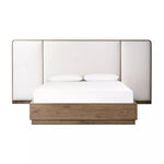 A plush, winged headboard adds dramatic scale and inviting comfort to this modern bed. Thick rails and a footboard with a plinth base have a rustic finish. Amethyst Home provides interior design, new home construction design consulting, vintage area rugs, and lighting in the Scottsdale metro area.