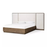 A plush, winged headboard adds dramatic scale and inviting comfort to this modern bed. Thick rails and a footboard with a plinth base have a rustic finish. Amethyst Home provides interior design, new home construction design consulting, vintage area rugs, and lighting in the Alpharetta metro area.