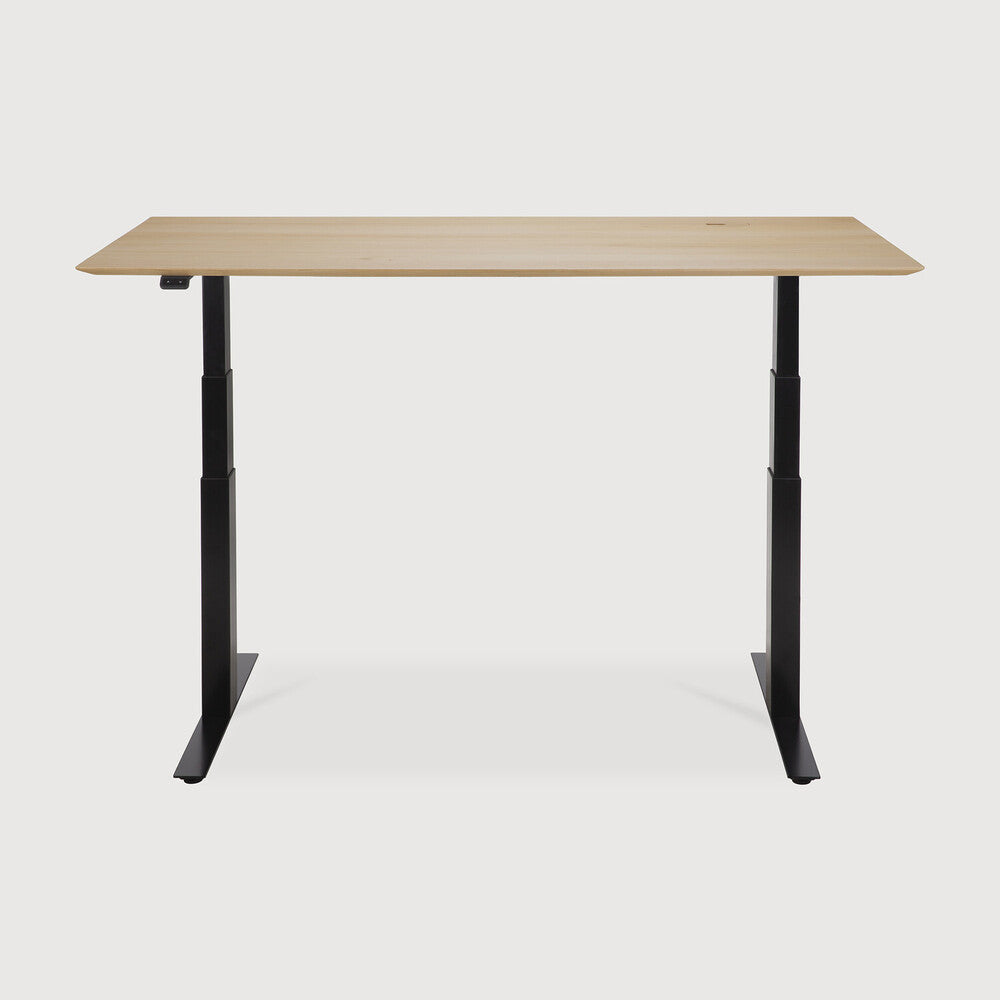 Featuring Bok Black Us Oak Adjustable Desk by Ethnicraft at Amethyst Home. The Bok adjustable desk was designed with the importance of health and good posture in mind. The motorised system in its legs allows the tabletop to be elevated to the height of your liking. That way, you can easily switch between sitting and standing throughout the workday. Choose between white or black me. Amethyst Home provides interior design, new construction, custom furniture, and area rugs in the Charlotte metro area