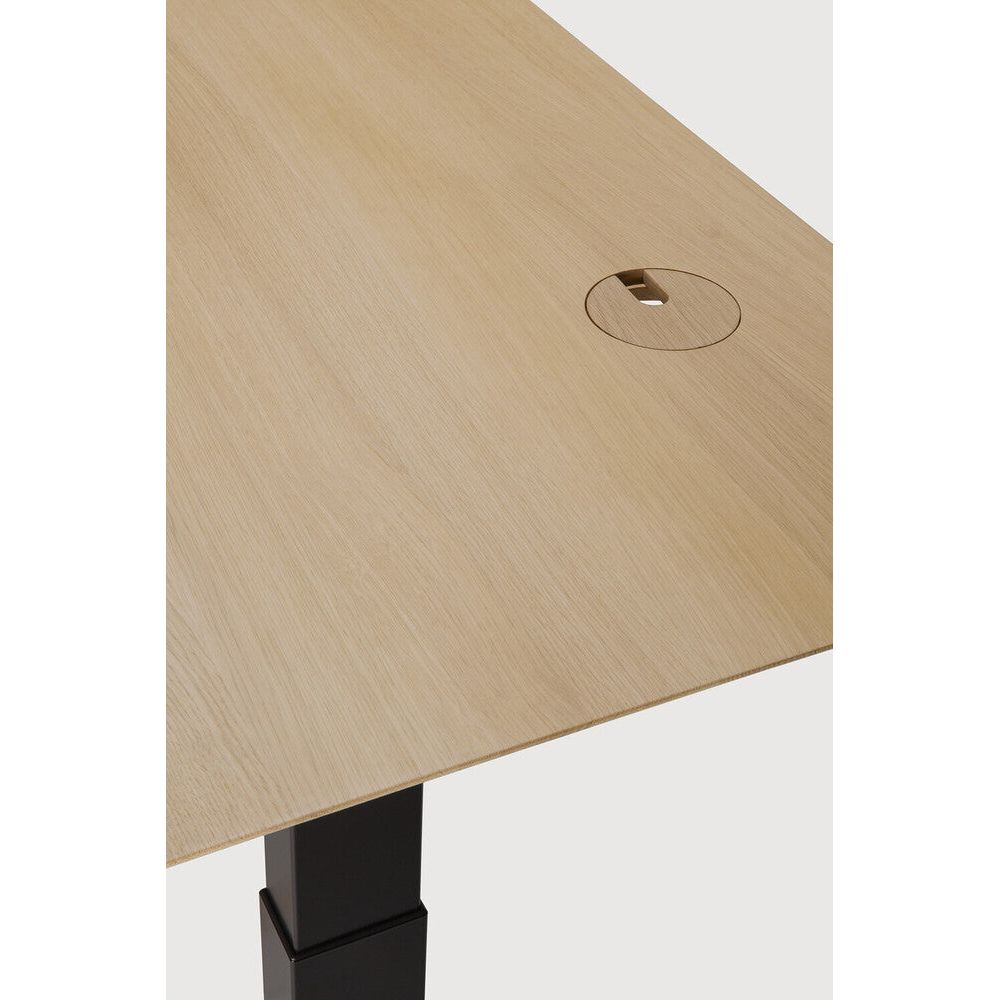 Featuring Bok Black Us Oak Adjustable Desk by Ethnicraft at Amethyst Home. The Bok adjustable desk was designed with the importance of health and good posture in mind. The motorised system in its legs allows the tabletop to be elevated to the height of your liking. That way, you can easily switch between sitting and standing throughout the workday. Choose between white or black meta. Amethyst Home provides interior design, new construction, custom furniture, and area rugs in the Houston metro area