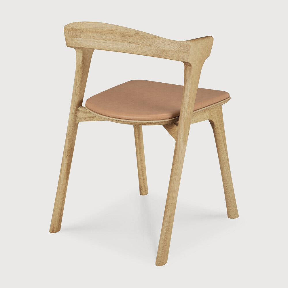 Featuring Bok Sienna Leather Varnished Oak Dining Chair by Ethnicraft at Amethyst Home. Reminiscent of a goat's curved horns, the Bok collection combines sculptural elegance and contemporary crafting into a graceful and airy form. Over the years, the Bok dining chair has become one of Ethnicraft's most recognisable designs.Weight : 15 lbs Dimensions: 21.5" W x 20" L x 30" H. Amethyst Home provides interior design, new construction, custom furniture, and area rugs in the Nashville metro area
