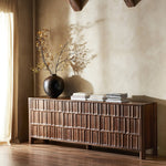 Featuring Ezri Cocoa Oak Sideboard by Four Hands at Amethyst Home. Grain and character variation within a solid oak finish give this sideboard organic visual interest. The carved design and floor-to-top cylinder legs give a primitive look that balances the movement of the wood pattern.Overall Dimensions: 98.00"w x 18.00"d x 34.00"hWeight : 245.38 lbsMaterials : Solid Oak. Amethyst Home provides interior design, new construction, custom furniture, and area rugs in the Tampa metro area