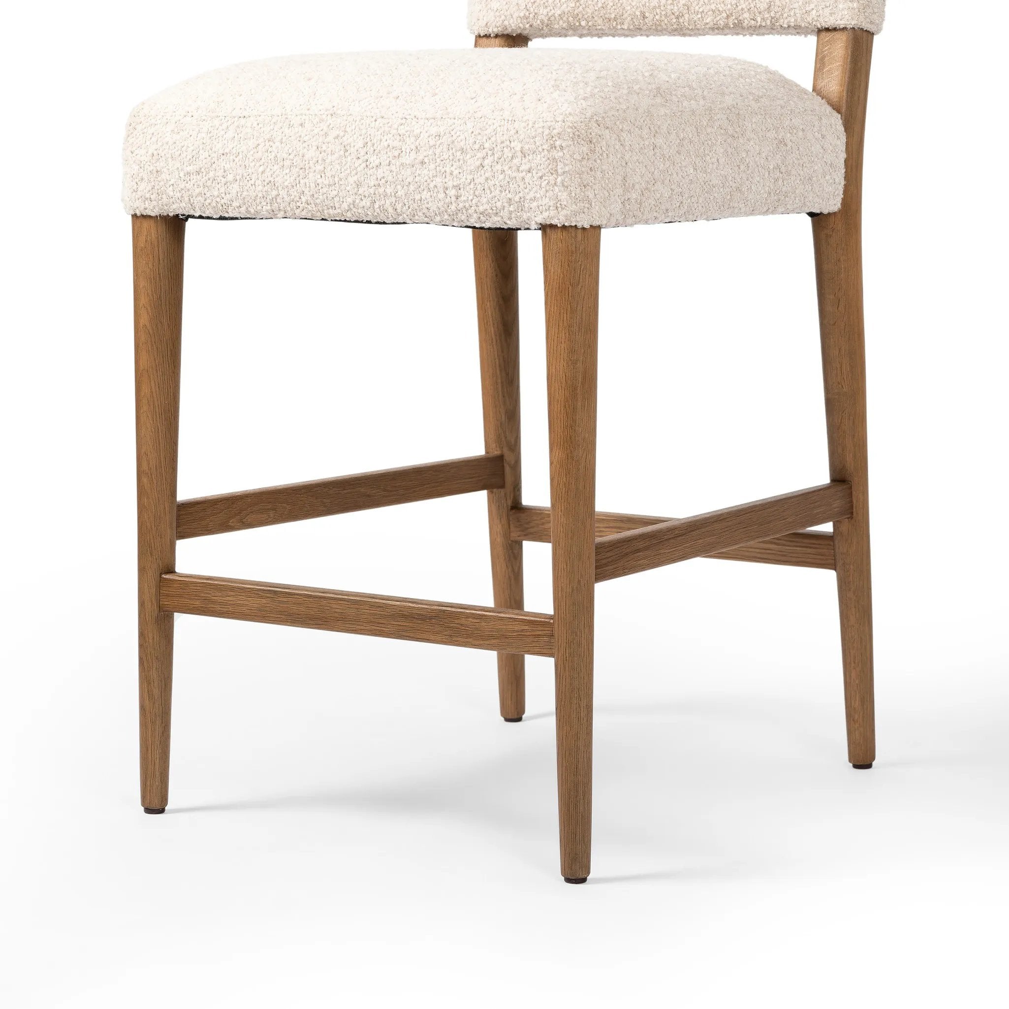 Featuring Abilene Somerton Ash Bar + Counter Stool by Four Hands at Amethyst Home. A heritage design gets a modern twist. Simple tapered legs of warm oak mark this dining room chair's traditional form, while an arched seat back with off-white upholstery updates this comfortable seating style, perfectly sized for the counter. Performance fabrics are specially c. Amethyst Home provides interior design, new home construction design consulting, vintage area rugs, and lighting in the Boston metro area.