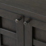 A transitional piece that works into your collection with ease. This solid oak sideboard is finished in a smoked black, highlighting natural graining inherent to rich character woods. Grid-like patterned doors bring dimension to clean, simple shaping, while interior shelving awaits storage of dinnerware, table linens and more. Amethyst Home provides interior design, new home construction design consulting, vintage area rugs, and lighting in the Kansas City metro area.
