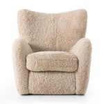 Relax into the curved arms and subtle wing back shape of this classic reading chair. Upholstered in an ethically sourced, natural beige shearling for extra comfort and texture. Crafted with S-spring suspension, a loose cushion and hidden legs beneath Amethyst Home provides interior design, new home construction design consulting, vintage area rugs, and lighting in the Austin metro area.