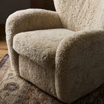 Relax into the curved arms and subtle wing back shape of this classic reading chair. Upholstered in an ethically sourced, natural beige shearling for extra comfort and texture. Crafted with S-spring suspension, a loose cushion and hidden legs beneath Amethyst Home provides interior design, new home construction design consulting, vintage area rugs, and lighting in the Laguna Beach metro area.