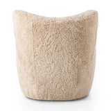 Relax into the curved arms and subtle wing back shape of this classic reading chair. Upholstered in an ethically sourced, natural beige shearling for extra comfort and texture. Crafted with S-spring suspension, a loose cushion and hidden legs beneath Amethyst Home provides interior design, new home construction design consulting, vintage area rugs, and lighting in the Nashville metro area.