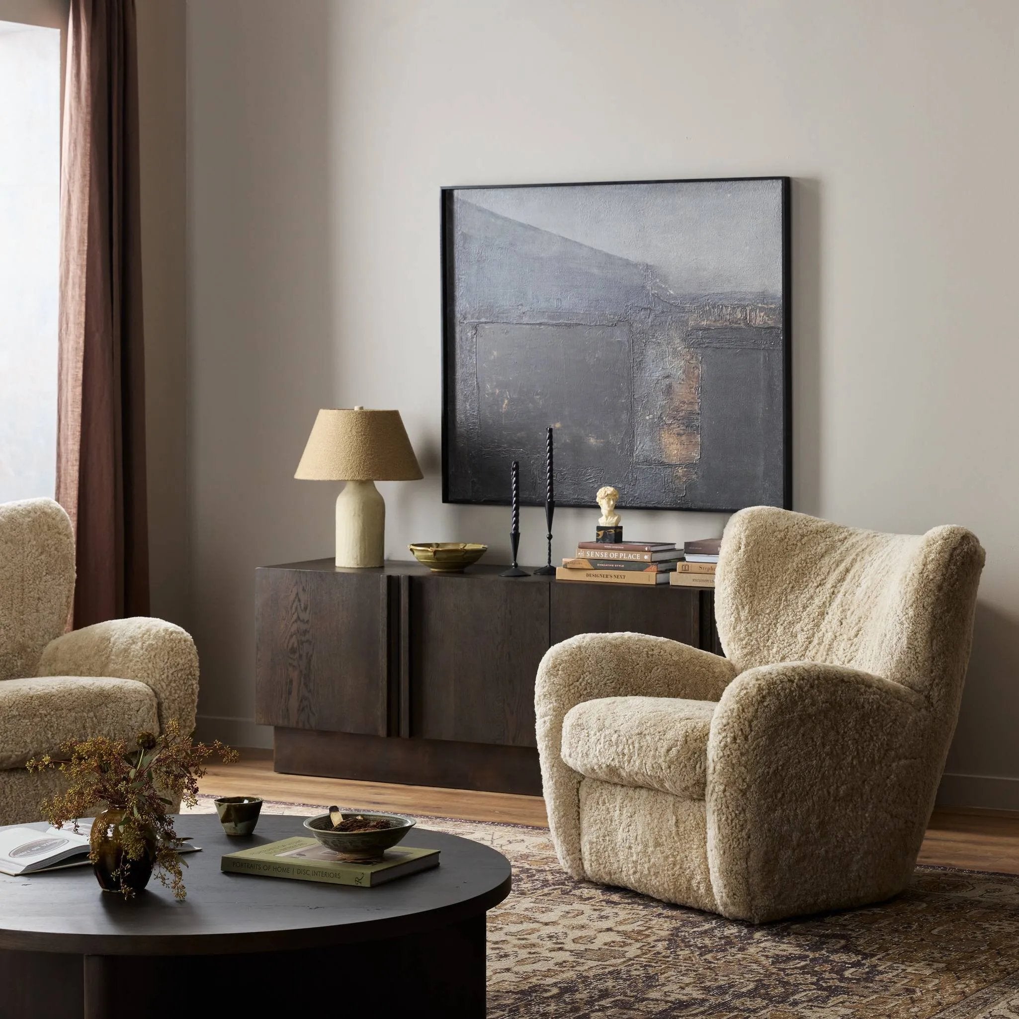 Relax into the curved arms and subtle wing back shape of this classic reading chair. Upholstered in an ethically sourced, natural beige shearling for extra comfort and texture. Crafted with S-spring suspension, a loose cushion and hidden legs beneath Amethyst Home provides interior design, new home construction design consulting, vintage area rugs, and lighting in the Portland metro area.