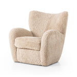 Relax into the curved arms and subtle wing back shape of this classic reading chair. Upholstered in an ethically sourced, natural beige shearling for extra comfort and texture. Crafted with S-spring suspension, a loose cushion and hidden legs beneath Amethyst Home provides interior design, new home construction design consulting, vintage area rugs, and lighting in the Salt Lake City metro area.