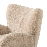 Relax into the curved arms and subtle wing back shape of this classic reading chair. Upholstered in an ethically sourced, natural beige shearling for extra comfort and texture. Crafted with S-spring suspension, a loose cushion and hidden legs beneath Amethyst Home provides interior design, new home construction design consulting, vintage area rugs, and lighting in the Tampa metro area.