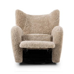 Relax into the curved arms and subtle wingback shape of this classic reading chair, featuring a reclining mechanism for ultimate comfort. Upholstered in an ethically sourced, natural beige shearling for extra comfort and texture. Crafted with S-spring suspension, a loose cushion and hidden legs beneath. Amethyst Home provides interior design, new home construction design consulting, vintage area rugs, and lighting in the Dallas metro area.