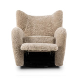 Relax into the curved arms and subtle wingback shape of this classic reading chair, featuring a reclining mechanism for ultimate comfort. Upholstered in an ethically sourced, natural beige shearling for extra comfort and texture. Crafted with S-spring suspension, a loose cushion and hidden legs beneath. Amethyst Home provides interior design, new home construction design consulting, vintage area rugs, and lighting in the Dallas metro area.