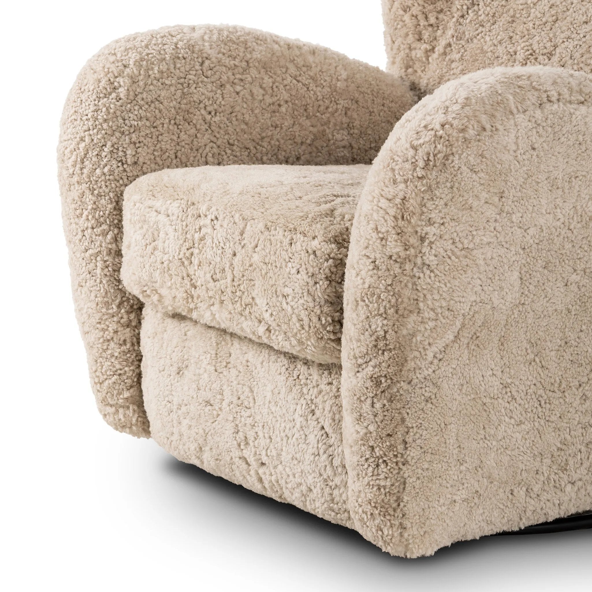 Relax into the curved arms and subtle wingback shape of this classic reading chair, featuring a reclining mechanism for ultimate comfort. Upholstered in an ethically sourced, natural beige shearling for extra comfort and texture. Crafted with S-spring suspension, a loose cushion and hidden legs beneath. Amethyst Home provides interior design, new home construction design consulting, vintage area rugs, and lighting in the Kansas City metro area.