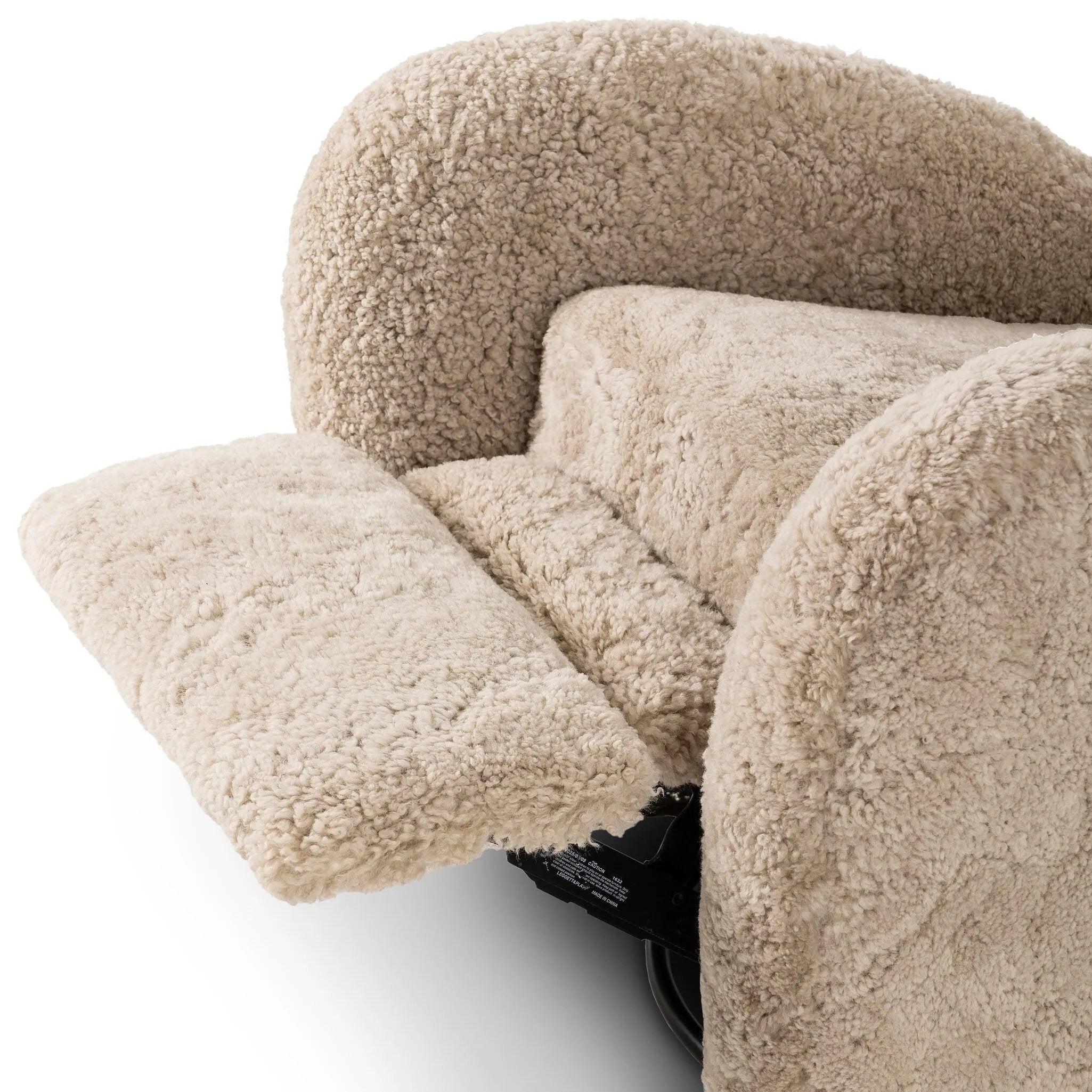 Relax into the curved arms and subtle wingback shape of this classic reading chair, featuring a reclining mechanism for ultimate comfort. Upholstered in an ethically sourced, natural beige shearling for extra comfort and texture. Crafted with S-spring suspension, a loose cushion and hidden legs beneath. Amethyst Home provides interior design, new home construction design consulting, vintage area rugs, and lighting in the Newport Beach metro area.