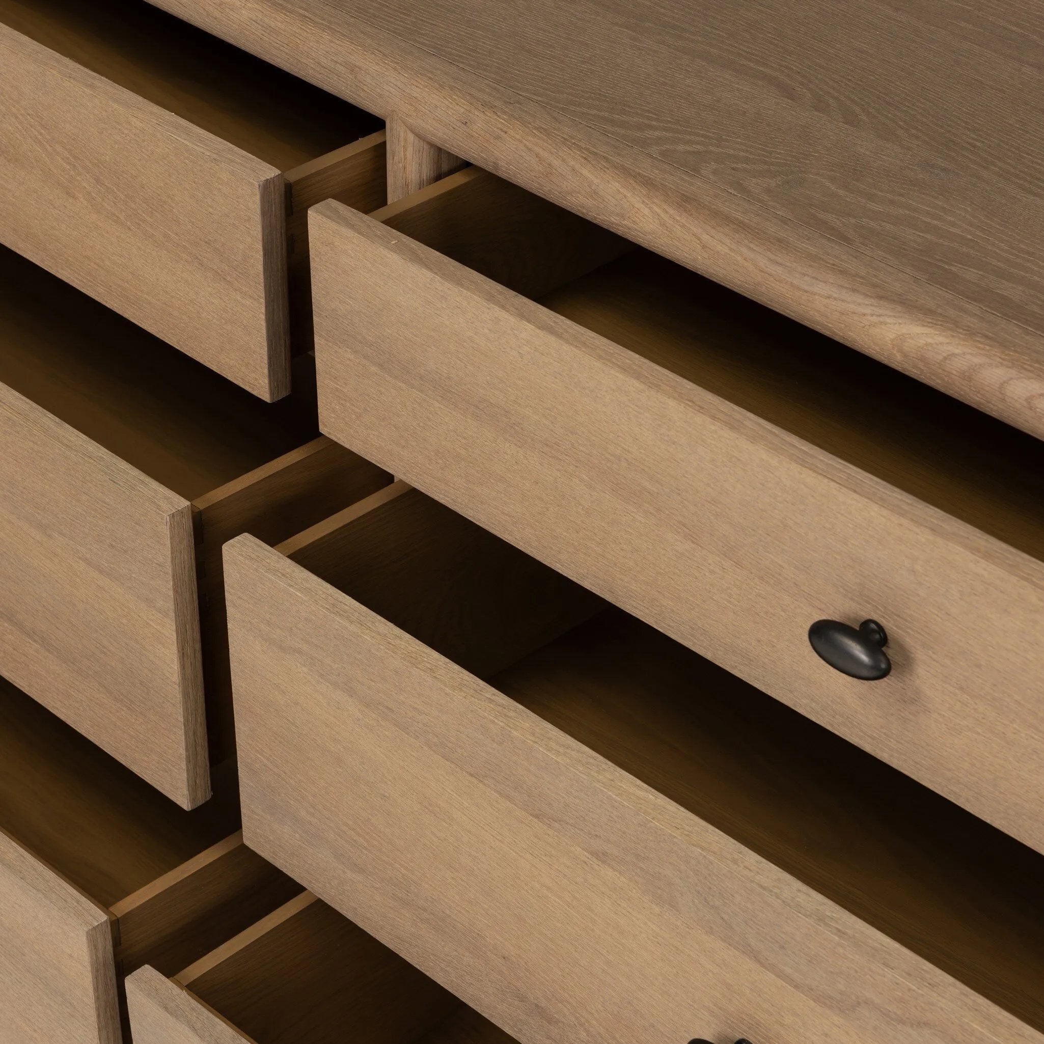Crafted from sandy solid oak in a waterfall silhouette, this dresser adds a touch of contemporary simplicity to your bedroom. A bullnose edge and oval iron drawer pulls add variety.As lovers of natural design at Amethyst, we love the designer inspired Analisa 6 Drawer Dresser - Sandy Oak. Amethyst Home provides interior design, new home construction design consulting, vintage area rugs, and lighting in the Los Angeles metro area.